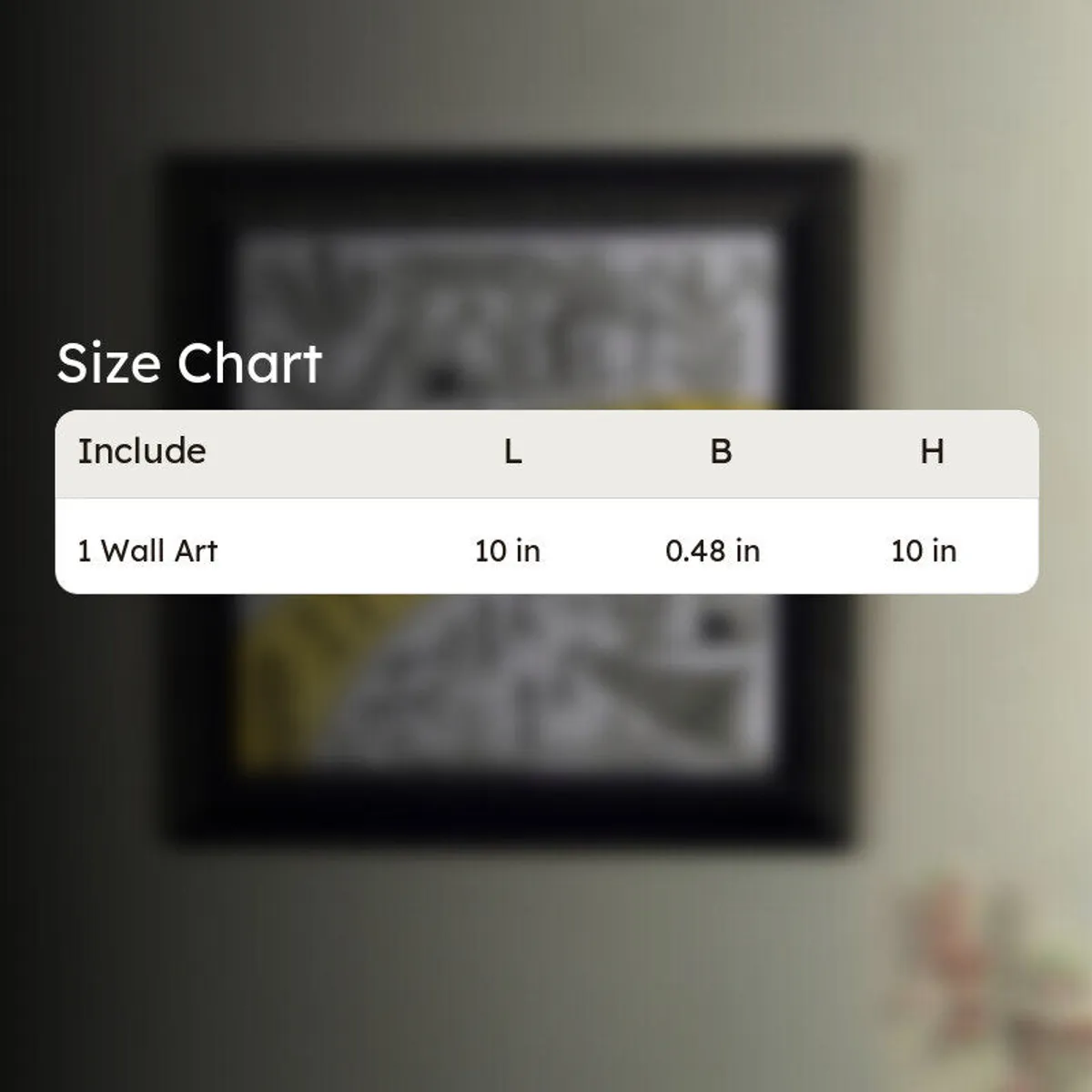 Blurred framed wall art behind a white size chart graphic