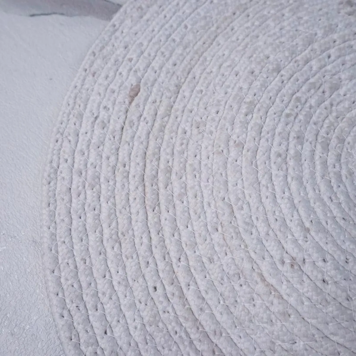 Close-up of the pale textured reverse side of a round table mat