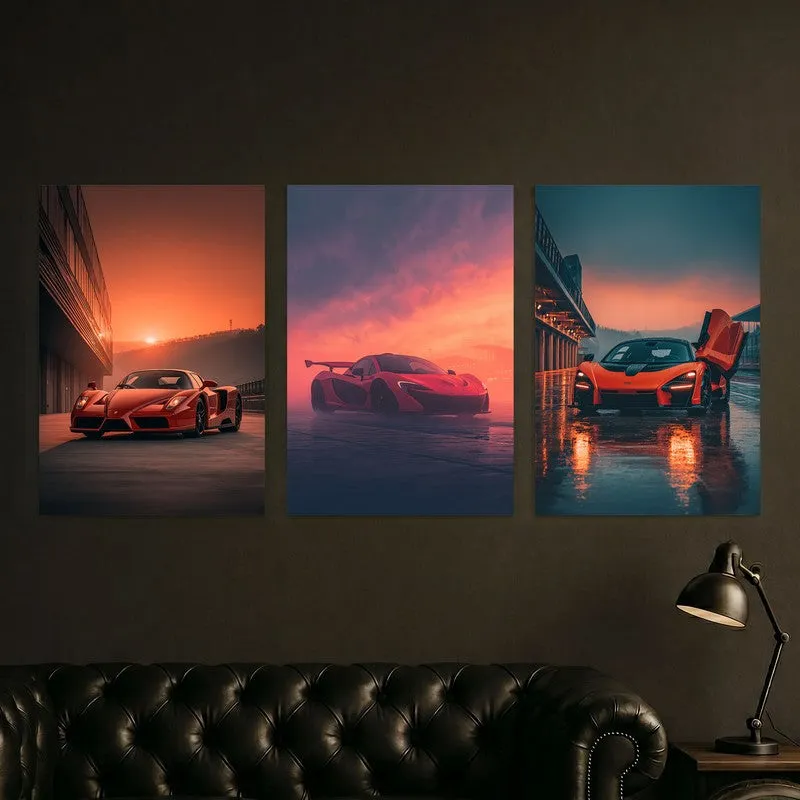 Three supercar posters displayed above a dark sofa