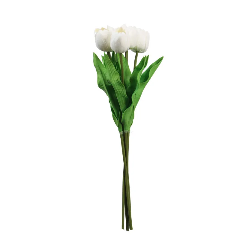 White artificial tulip flower stick with green leaves on a white background