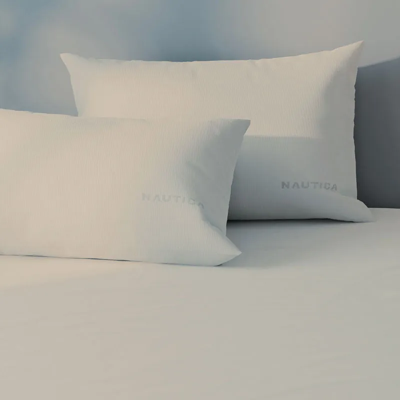 Close-up of two off white pillow covers on the bedsheet