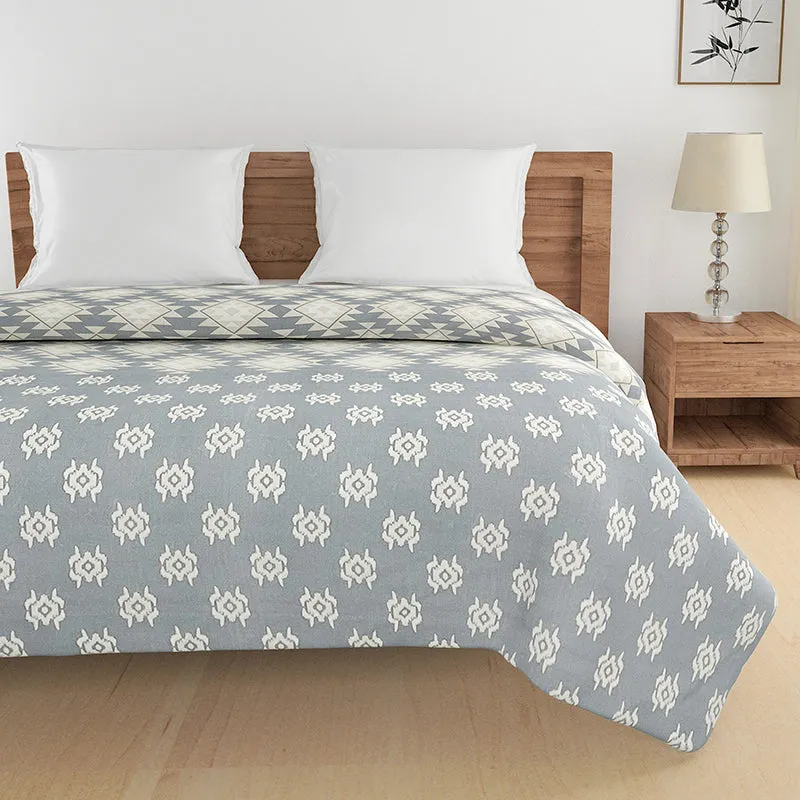 Front view of grey and white comforter styled on a double bed
