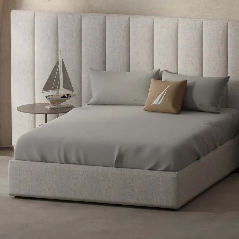 Silver-grey bedsheet styled on a modern bed with matching and accent pillows