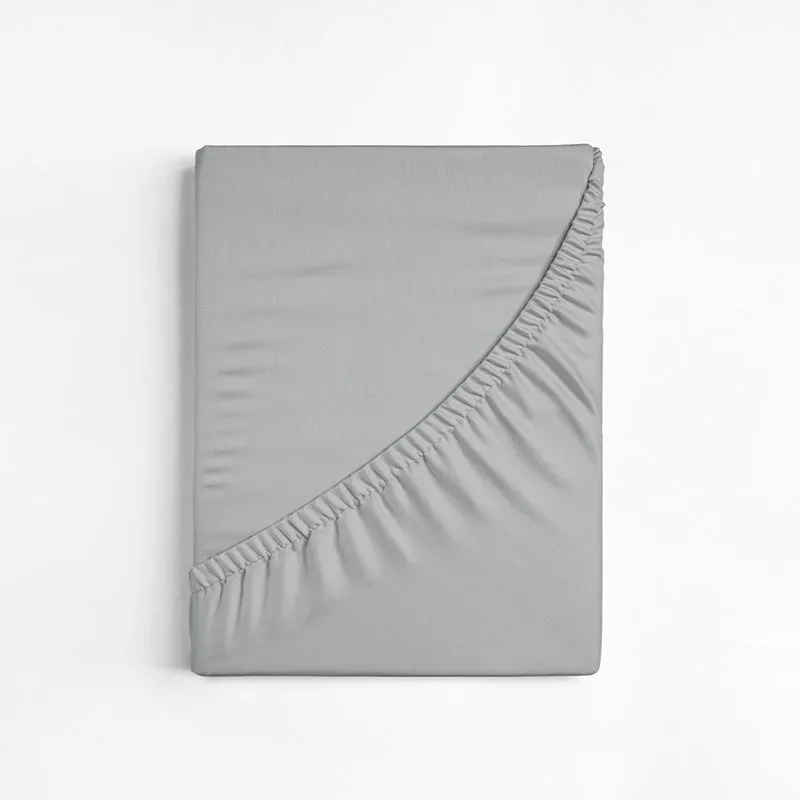 Folded light grey fitted bedsheet showing elasticated edge