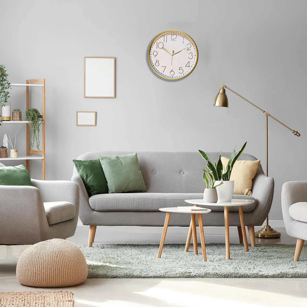 Gold and white round wall clock styled above a modern living room sofa