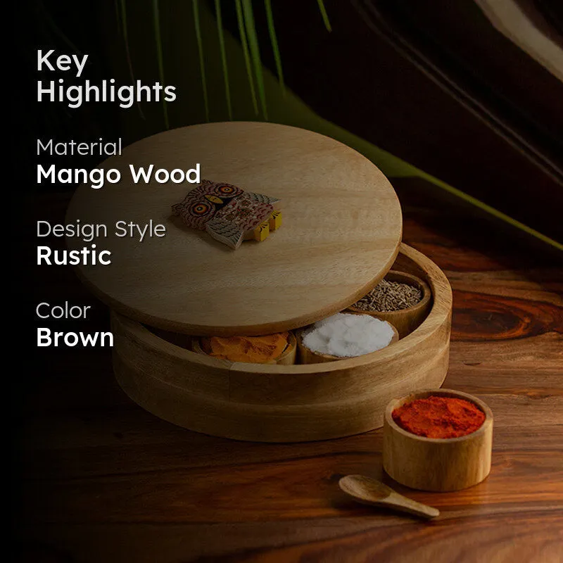 Brown wooden masala box styled with spices on a dark wooden surface