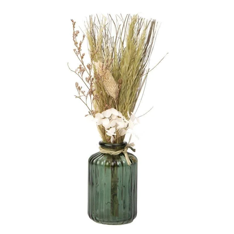 Green ribbed glass bottle vase with dried flowers on white background