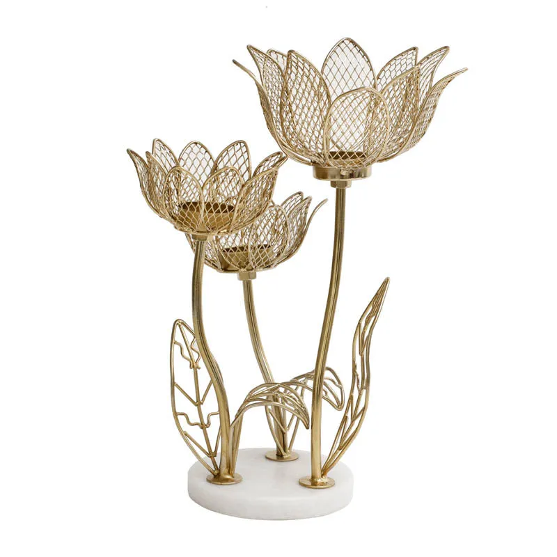 Gold-toned floral candle holder with three lotus cups and leaf details