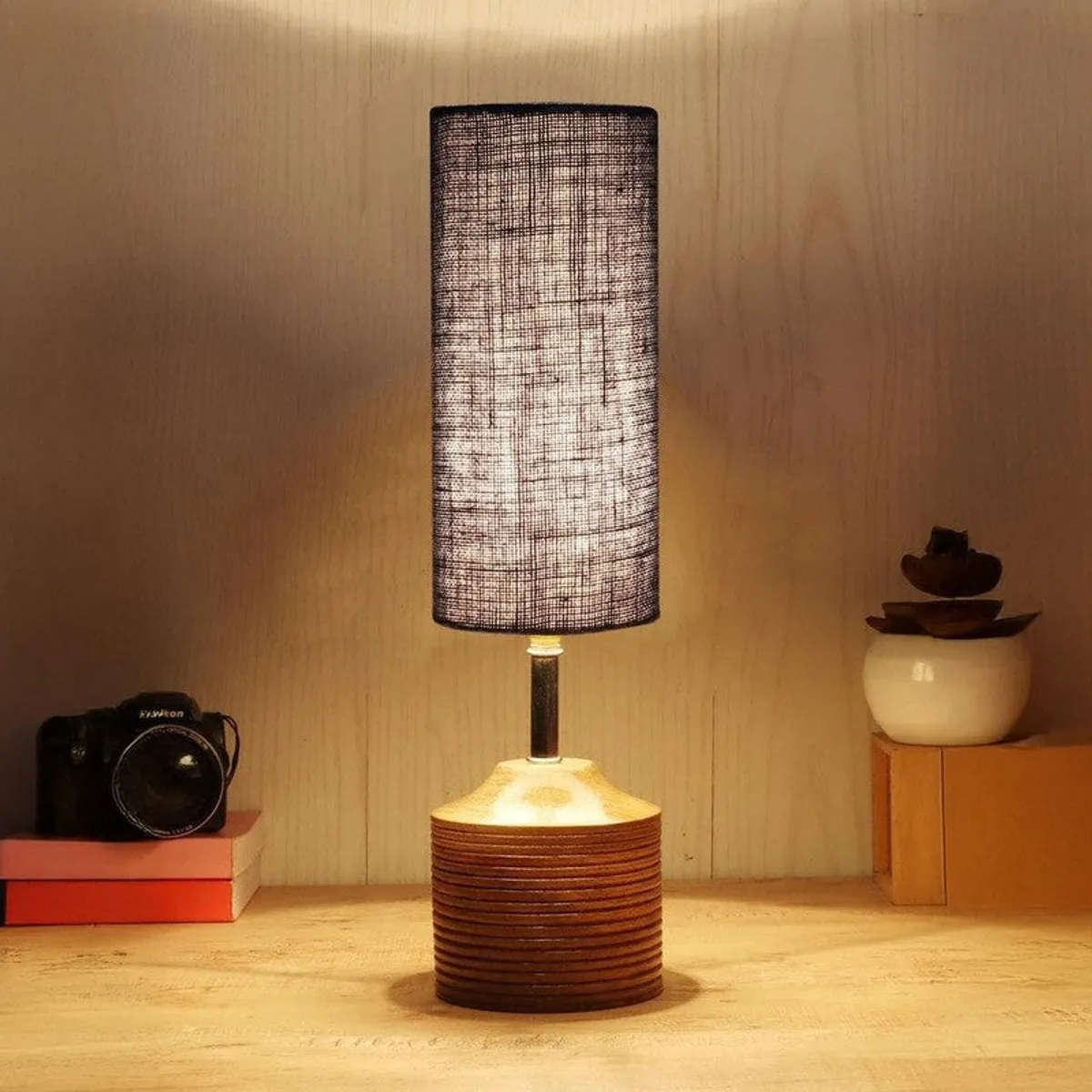 Glowing blue shade table lamp with brown base in warm setting