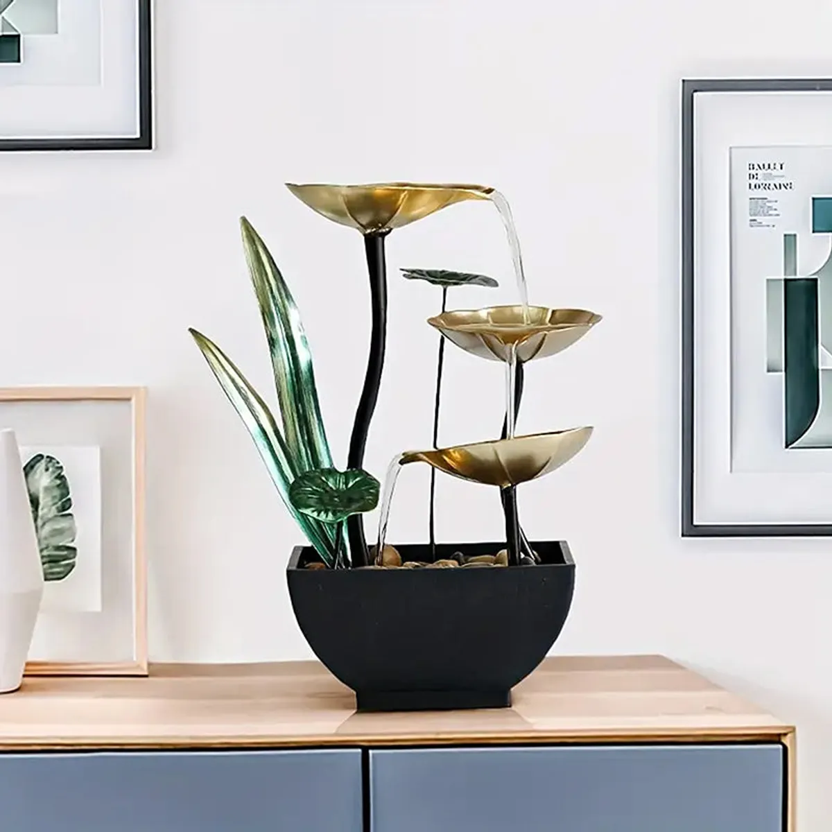 Tall lily pad fountain with gold bowls and black base styled on a console