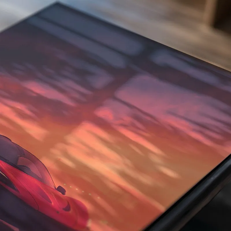 Close-up of glossy poster surface with a red sports car scene