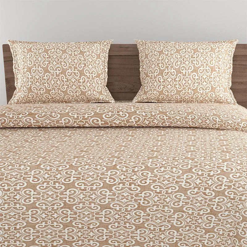 Close view of brown and white ethnic pattern on bedding and pillow covers