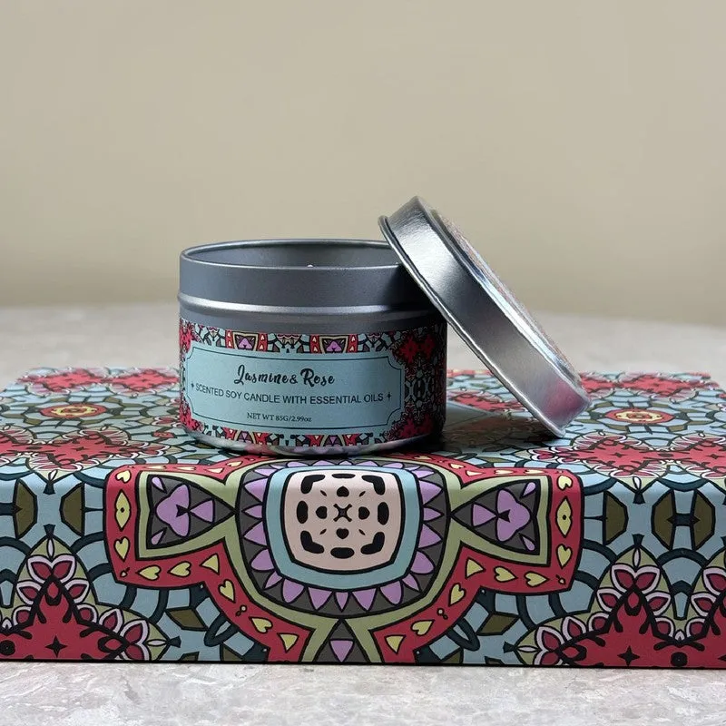 Scented candle in a round silver tin with its lid resting beside it