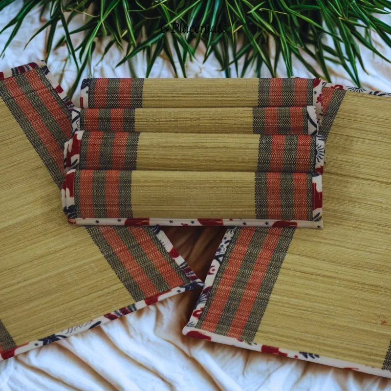 Six rectangular beige table mats with striped borders displayed together