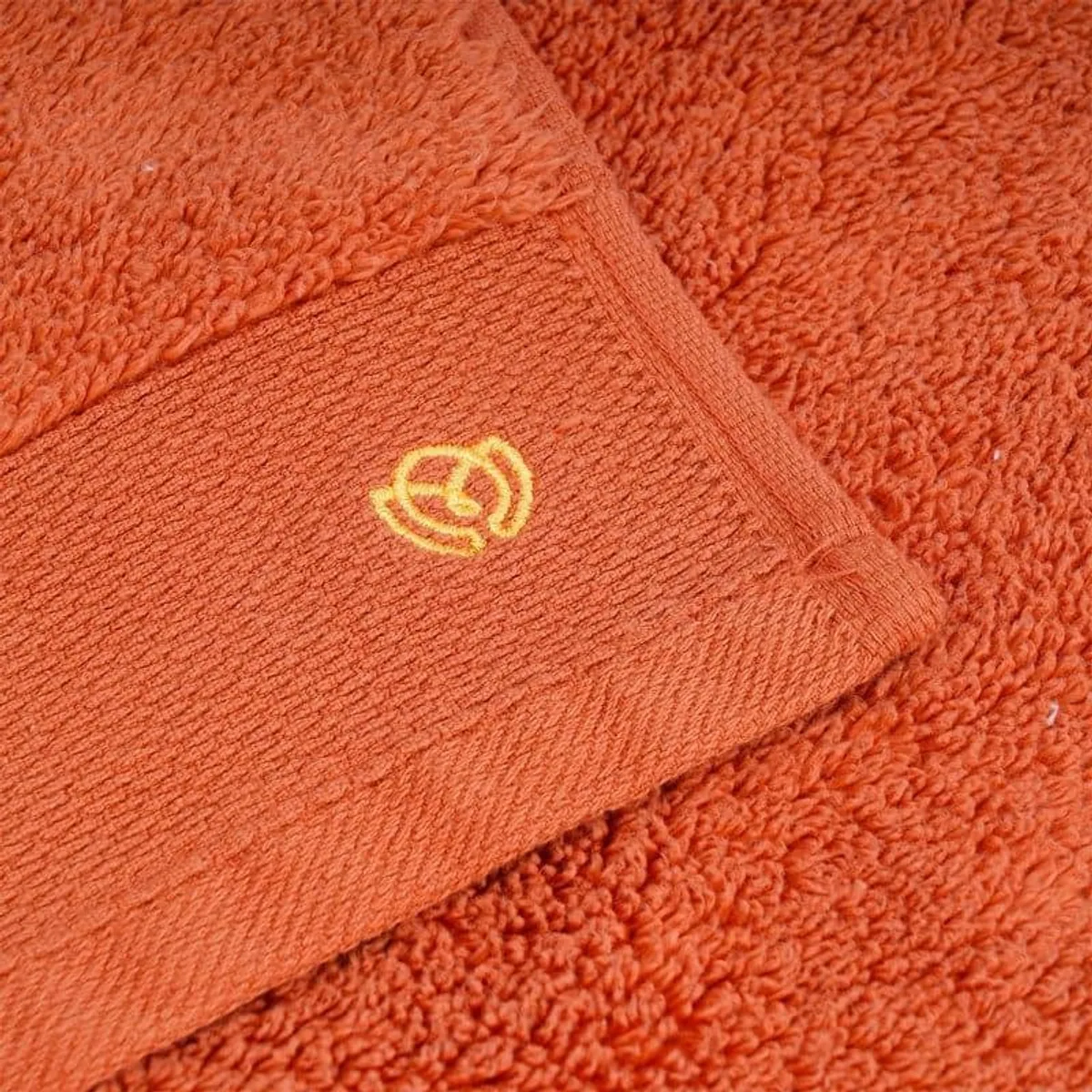 Close-up of the orange towel texture and border detail