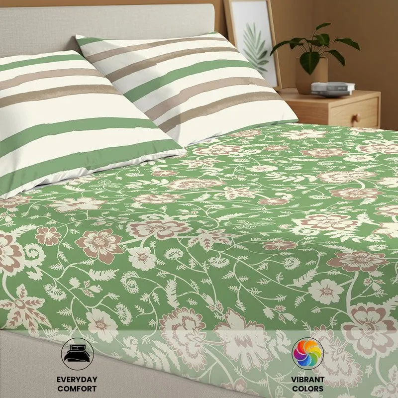 Close-up of green floral bedsheet fabric and striped pillow covers