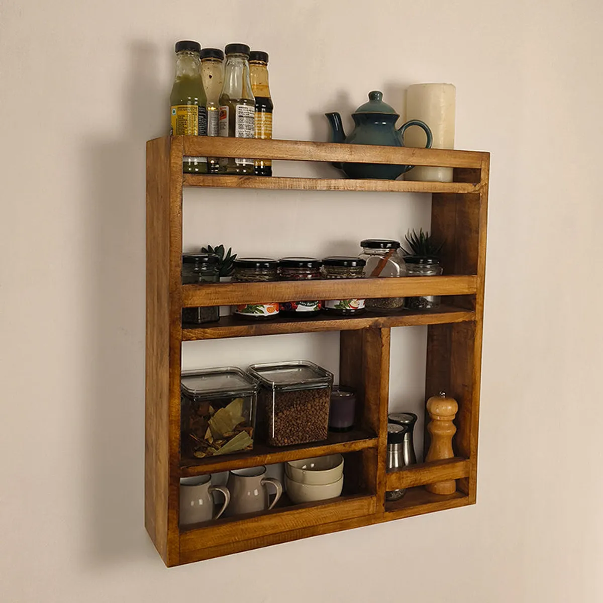 Angled view of a brown wooden kitchen rack with open shelves and compartments