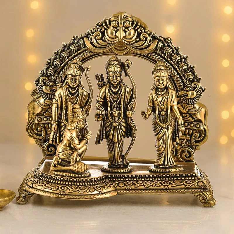 Front view of an ornate gold-toned brass Ram Darbar idol on a decorative base