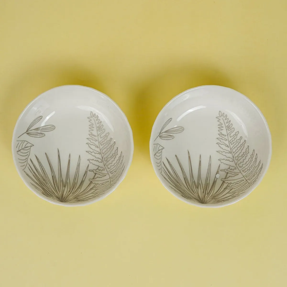 Porcelain serving set arranged on a dining table with two platters and bowls