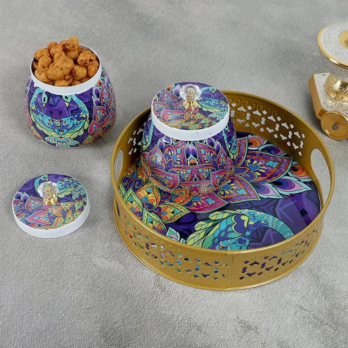 Peacock-patterned jars and gold tray shown from above