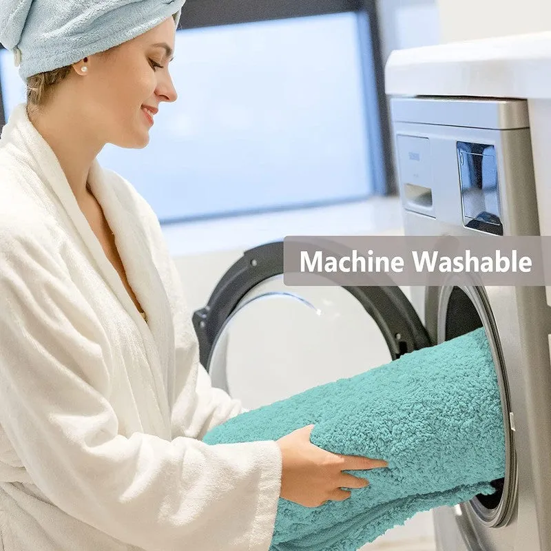 Sea blue bath mat shown being placed into a front-loading washing machine