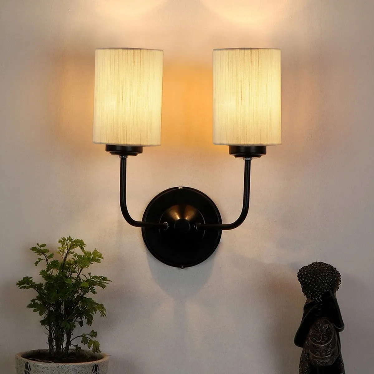 Lit twin wall lamp casting an upward glow on the wall