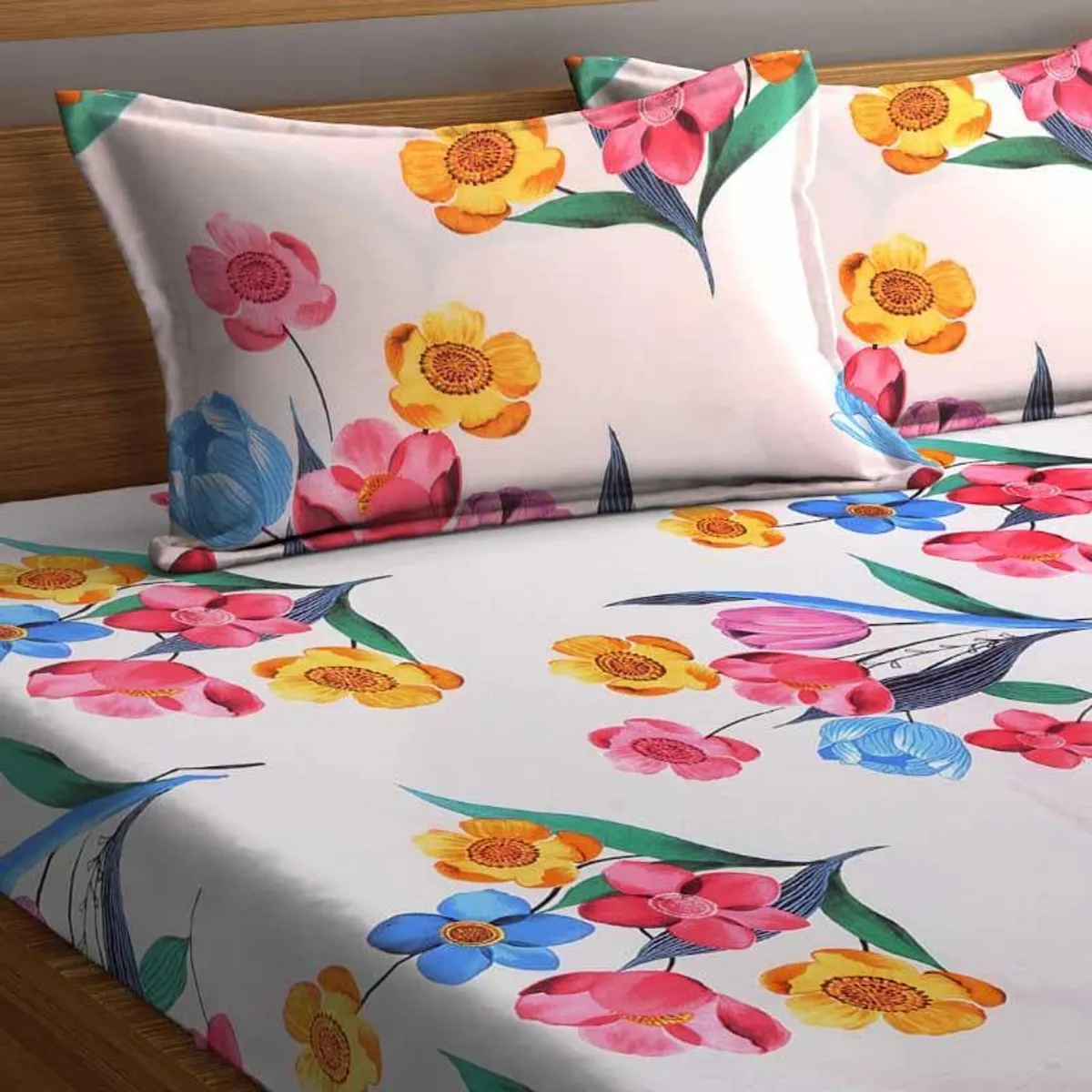 Close view of colourful floral pillow covers and bedsheet on a bed