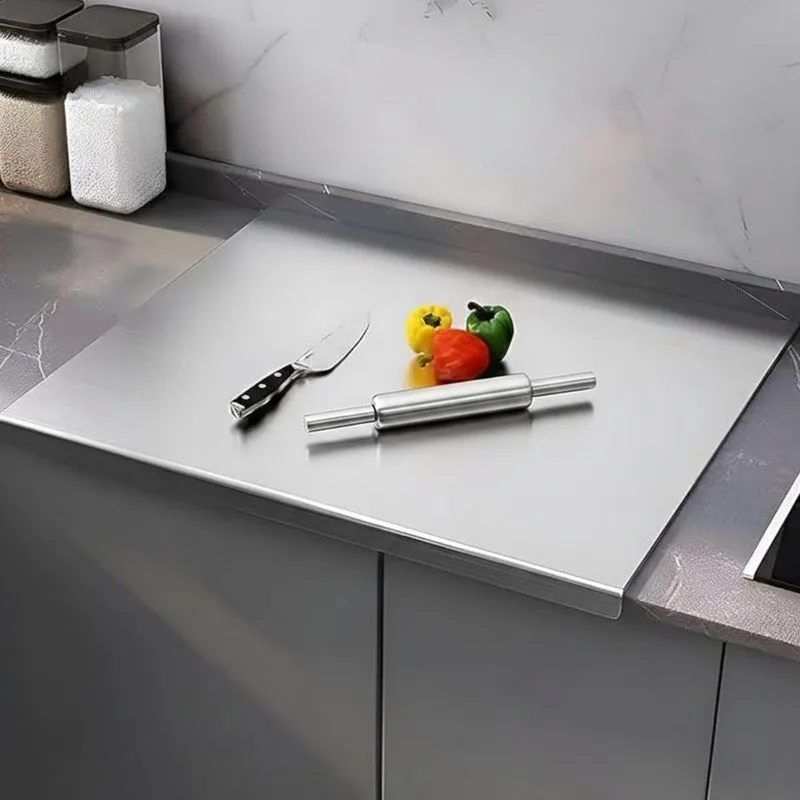 Silver steel rolling pin and board set placed on a kitchen countertop