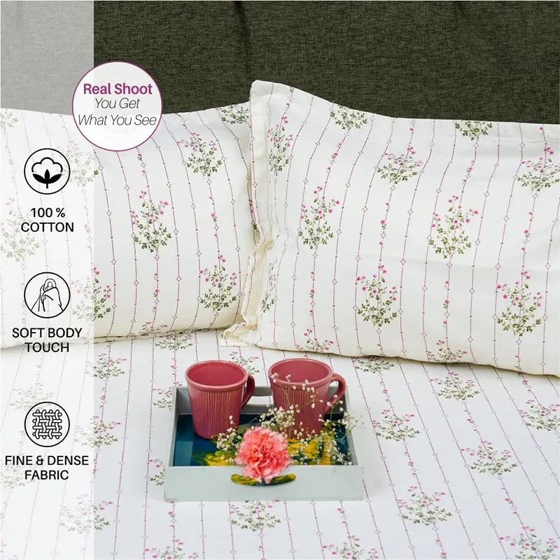 Close-up of matching pillow covers and floral striped bedsheet