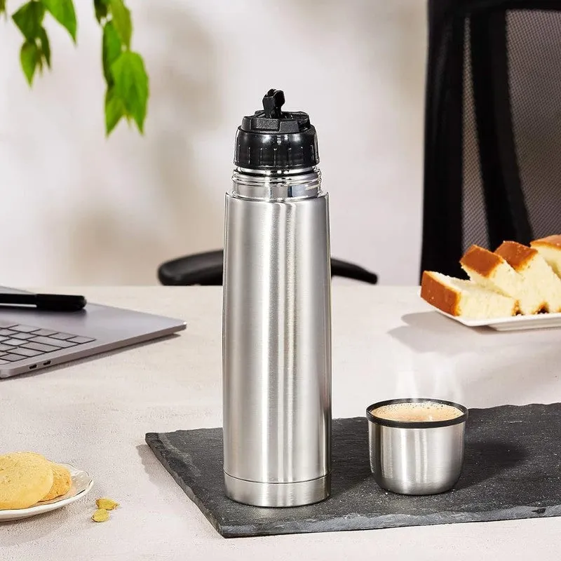 Open silver steel bottle with cup lid on an office desk