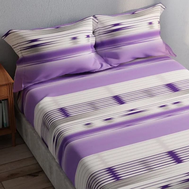 Angled view of purple and white geometric striped bedsheet and pillow covers