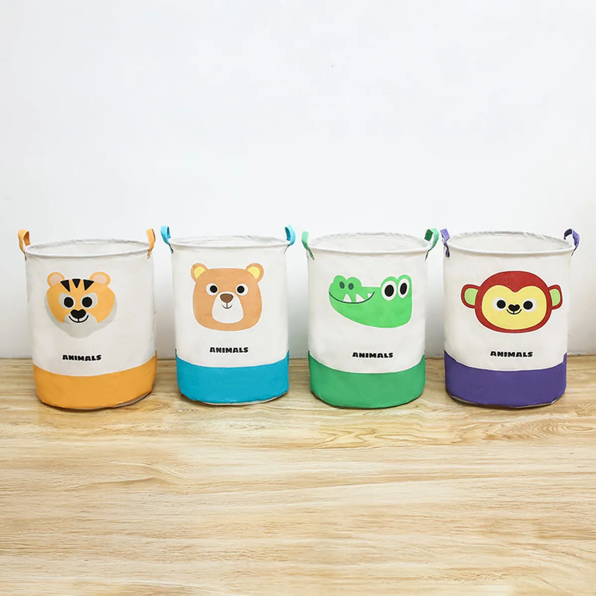Four animal-print laundry baskets displayed together in different colours