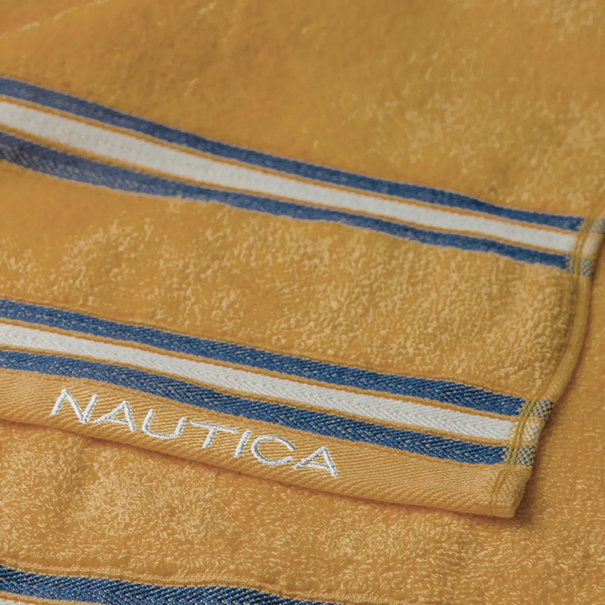 Yellow striped towel with white Nautica branding