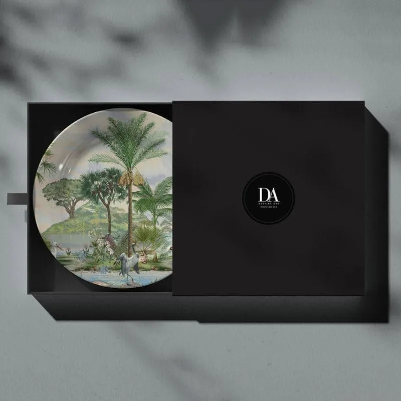 Round decorative plate in gift box with tropical landscape and cranes