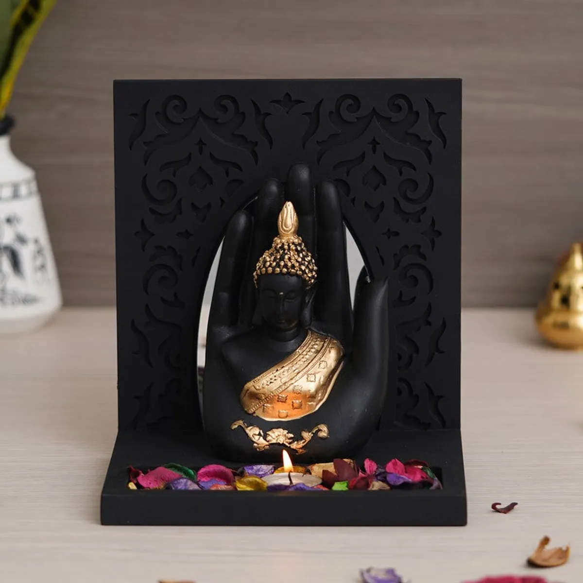 Buddha tea light holder with black carved panel and gold accents