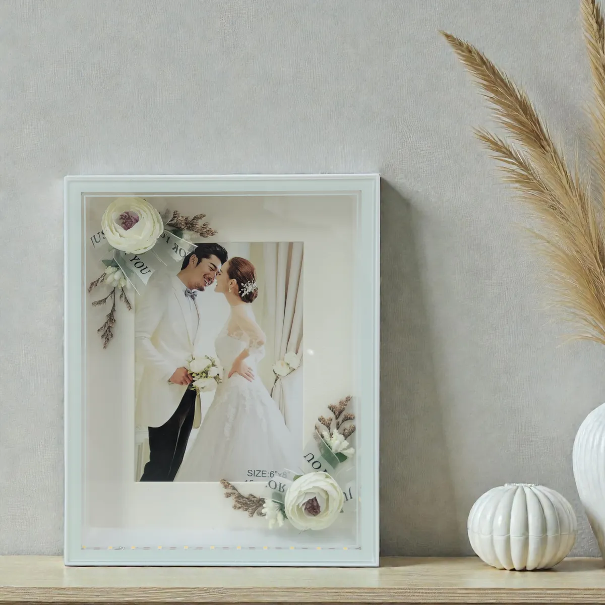 Close view of a white glowing frame displaying a wedding photograph.