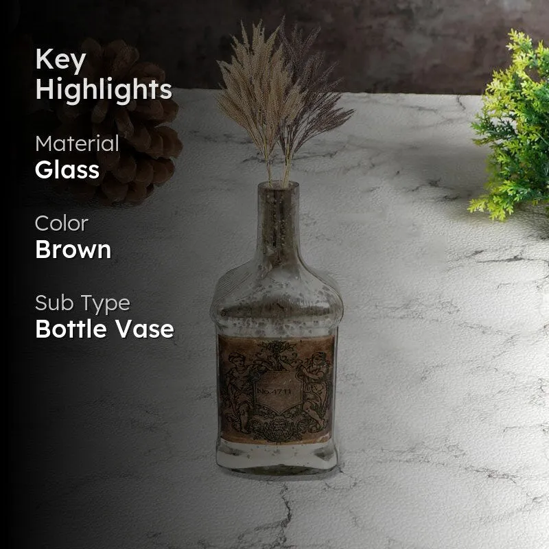 Brown bottle vase styled with dried grass on a tabletop