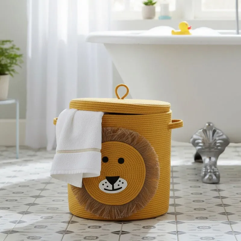 Yellow cylindrical storage basket with lid and lion face motif in a bathroom setting