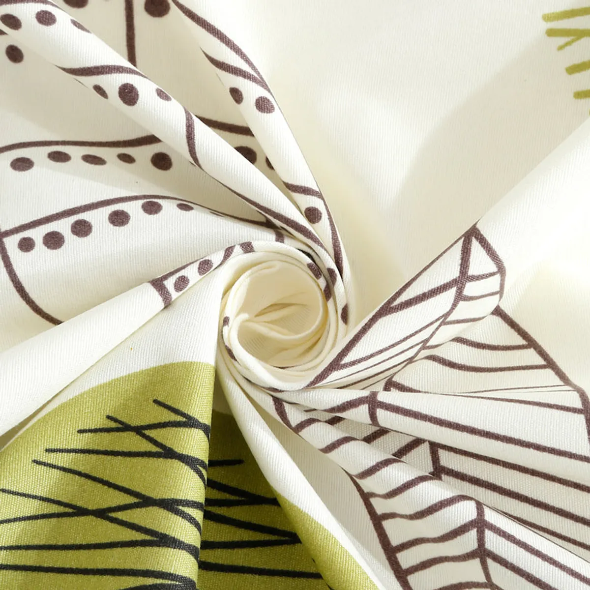 Close-up of printed fabric with leaf motif on off-white base
