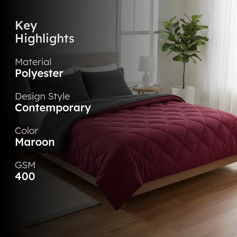 Maroon and grey comforter styled on a bed in a contemporary bedroom
