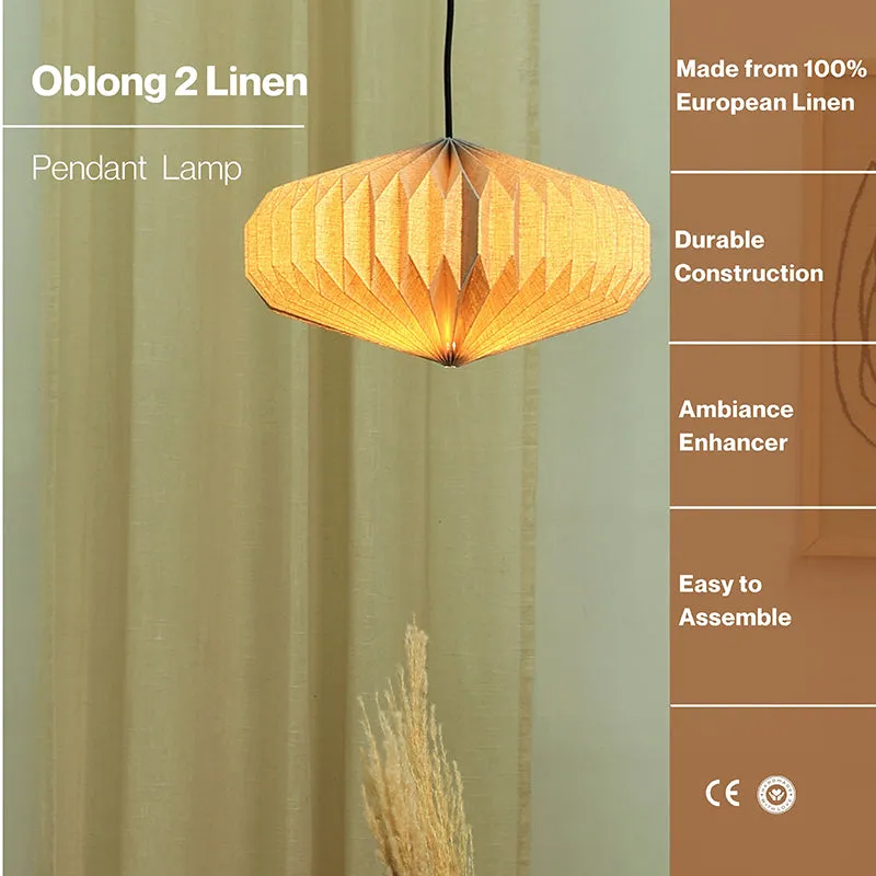 Lit oblong pleated ceiling lamp hanging in front of soft drapes
