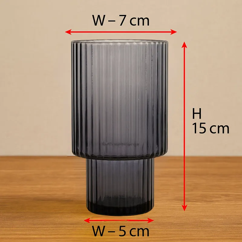 Grey ribbed glass vase shown front-on on a wooden surface