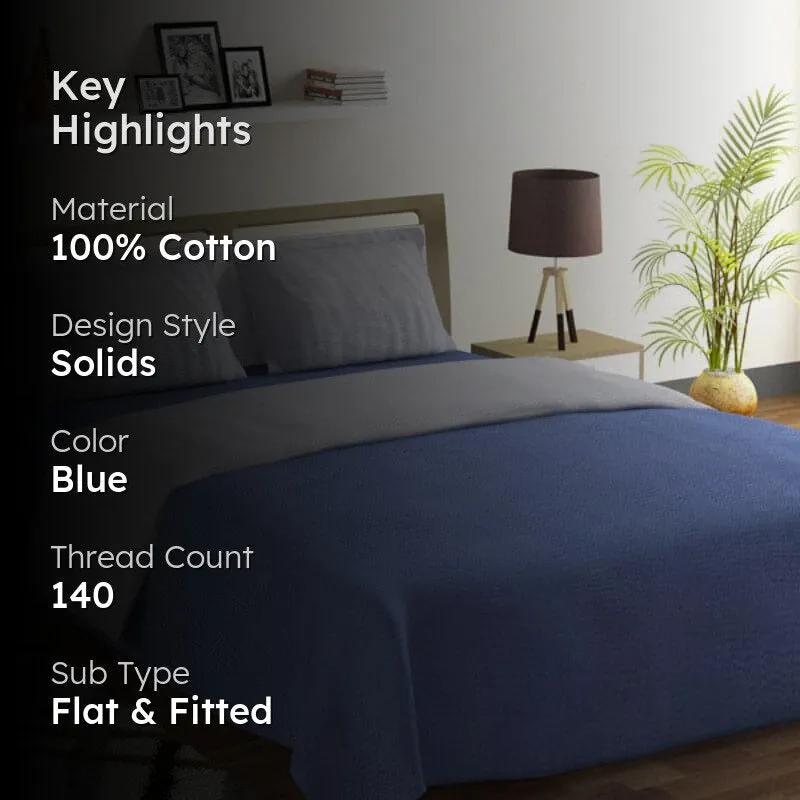 Navy blue bedsheet on a bed in a styled bedroom