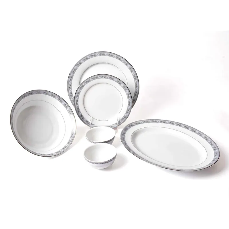 White porcelain 21-piece dinner set arranged with plates, bowls and an oval platter.