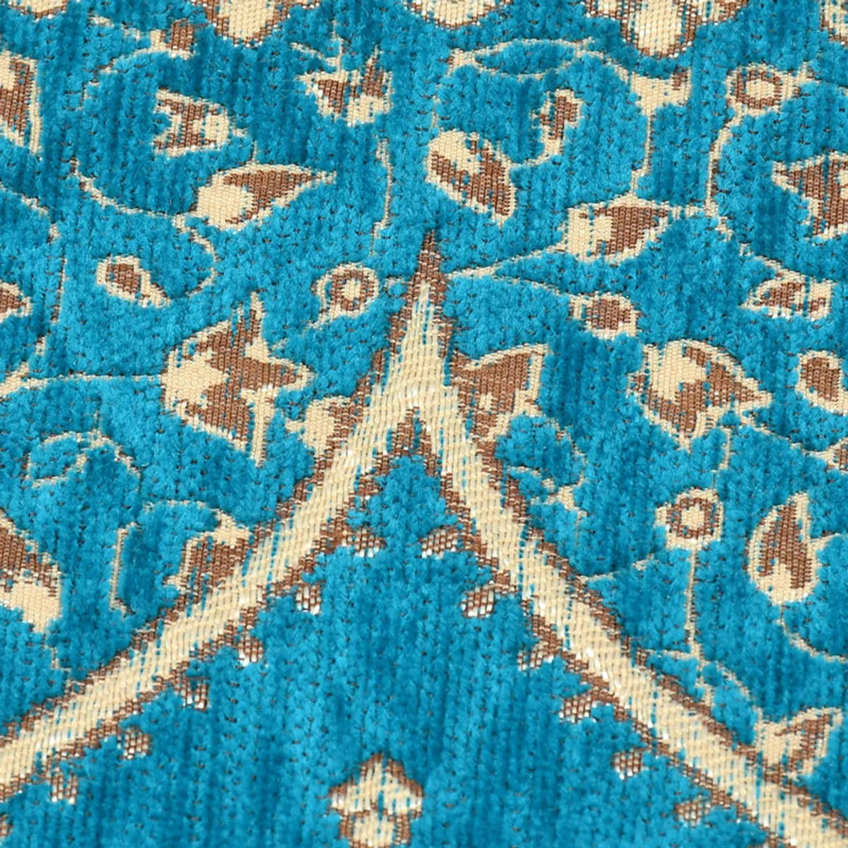Close-up showing the textured chenille surface and blue floral motifs