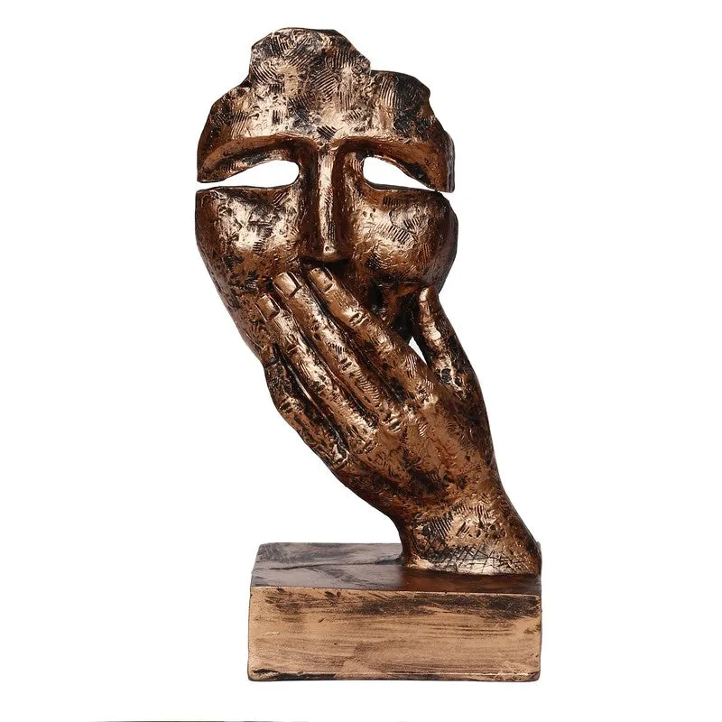 Front view of bronze abstract mask figurine with textured finish