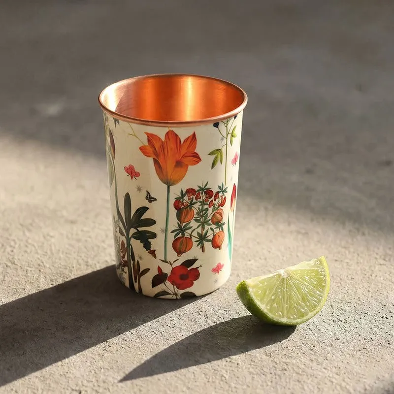 Close view of a floral copper tumbler with a warm copper interior
