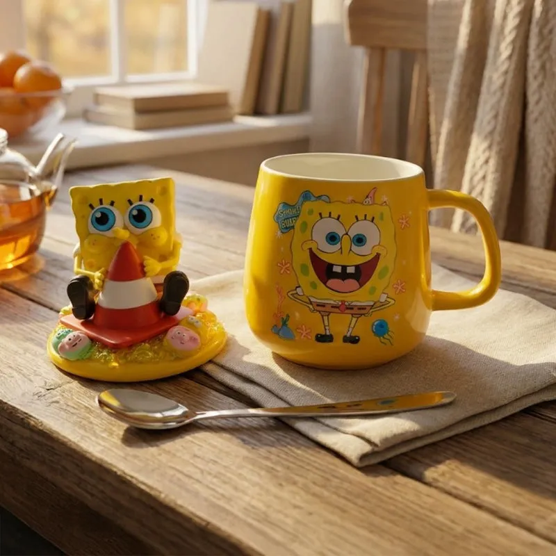 Yellow SpongeBob mug with matching lid figurine and spoon on a wooden table