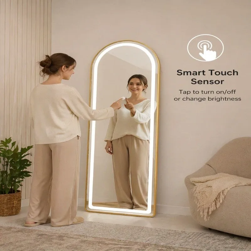 Person using the touch sensor on a gold arched LED floor mirror