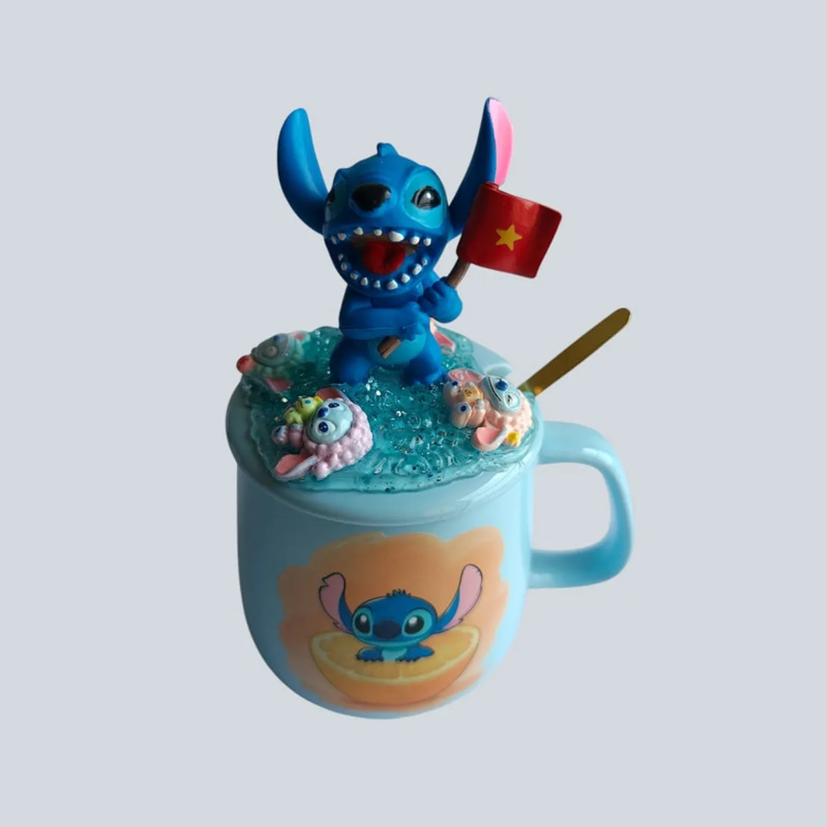 Front angled view of Stitch mug with lemon motif and sculpted lid